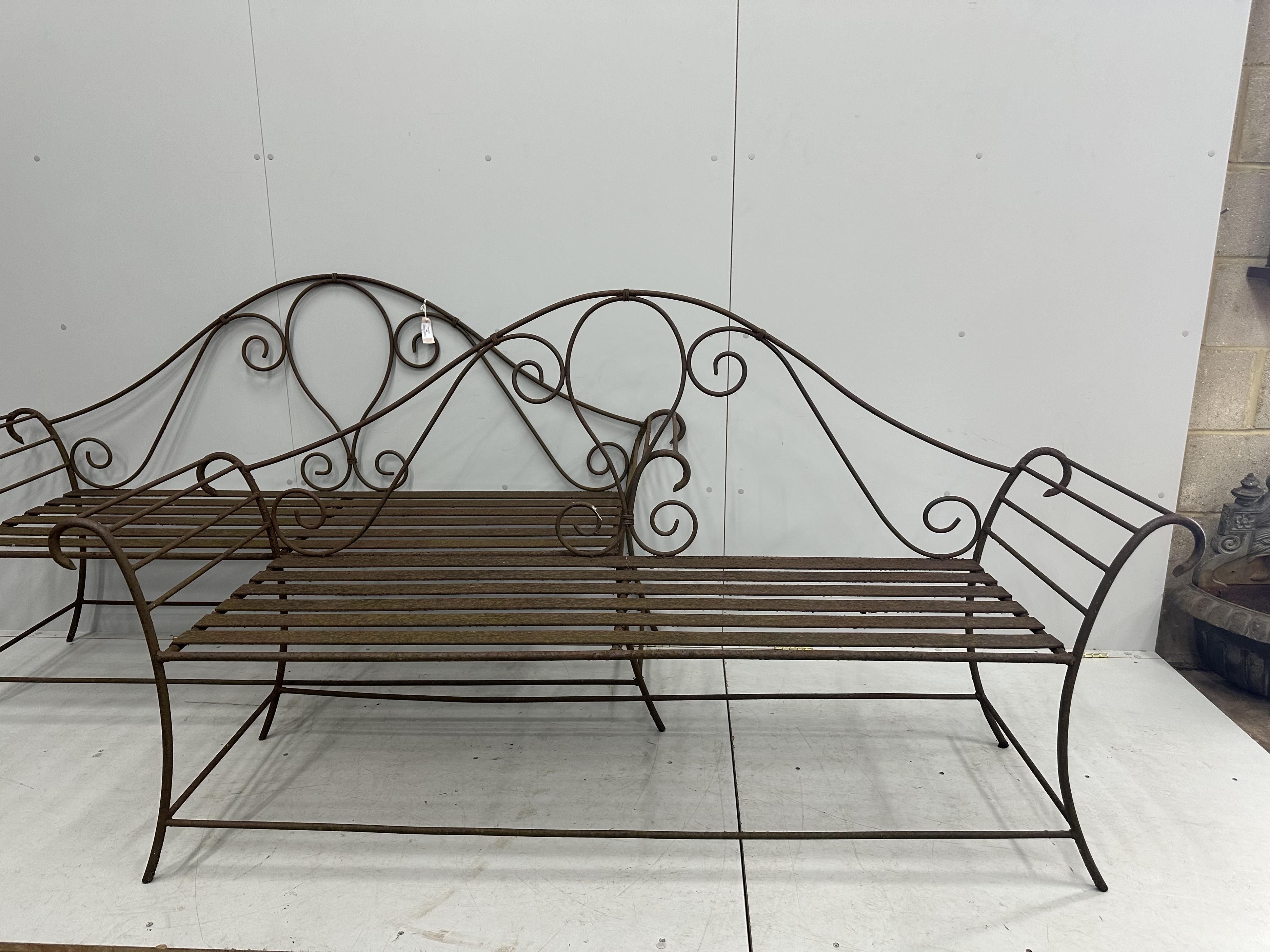 A pair of wrought iron garden benches, width 184cm, height 102cm. Condition - fair